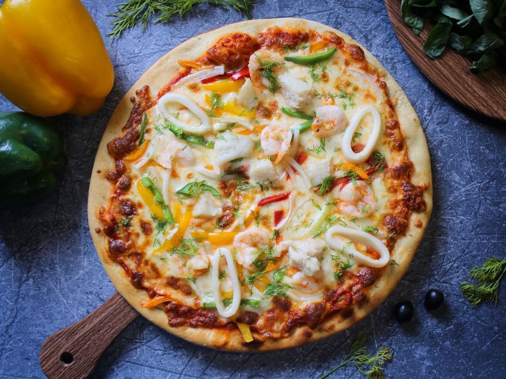 Seafood pizza topped with prawns, calamari and capsicum