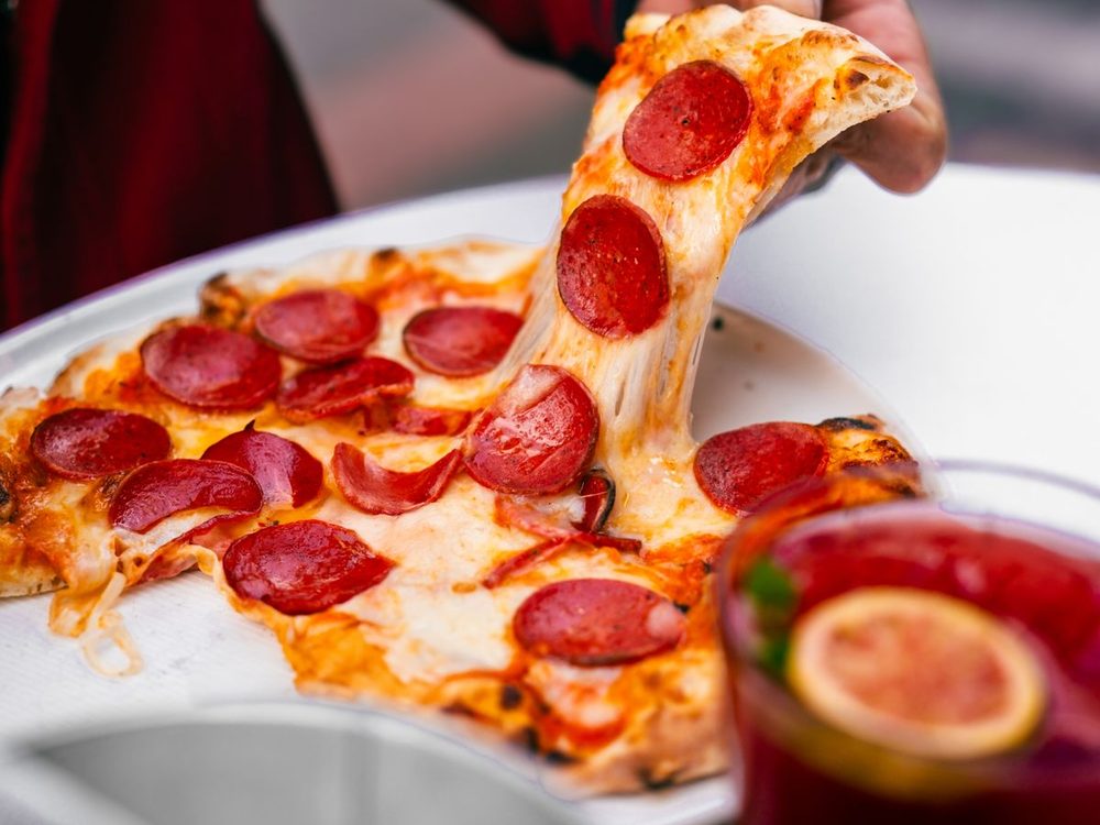 Traditional pepperoni pizza with a cheesy pull